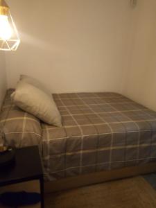 a bed in a room with a pillow on it at Apartamento cama 105 ONTUR in Murcia