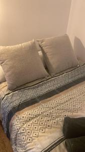 a bed with two pillows and a keyboard on it at Apartamento cama 105 ONTUR in Murcia