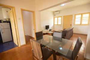 a kitchen and a living room with a dining table at Apartamento Vista Mar in São Tomé