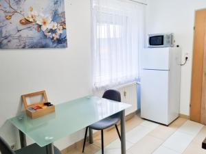 a kitchen with a table and a refrigerator at Da Vinci Apartment in Kapfenberg