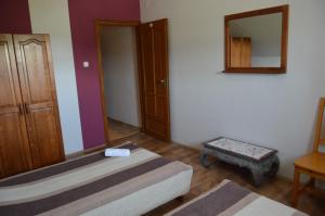 A bed or beds in a room at Régi Csárda és Panzió