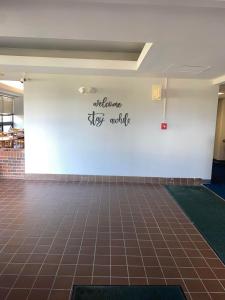 a room with a white wall and a tile floor at Illini Inn & Suites in Rantoul