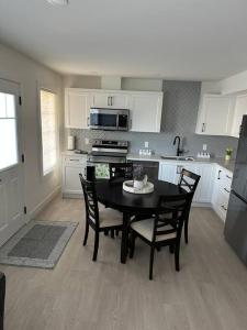 a kitchen with a table and chairs in a kitchen at The Royal Bay Escape: Cozy 2 bedrooms garden suite in Colwood