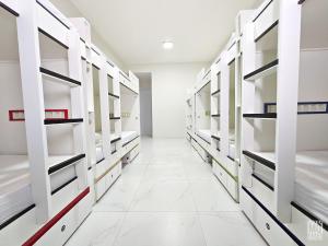 a walk in closet with white shelves at MANERO HOSTEL e POUSADA in Natal