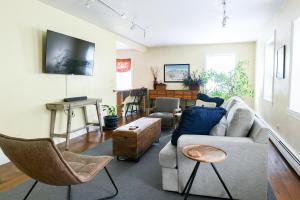 a living room with a couch and chairs at 1820 House - VT Charm + Modern Comforts + Hot Tub in Stowe