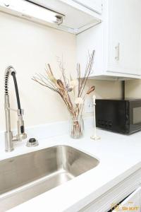 a kitchen sink with a vase of flowers on it at Your home away from home! in Jackson