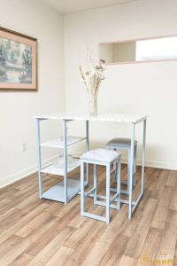 a white table and two stools in a room at Your home away from home! in Jackson