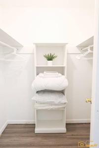a stack of towels on a shelf in a room at Your home away from home! in Jackson