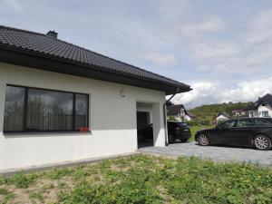 a white house with two cars parked in a driveway at New House White near Targi Kielce in Kielce