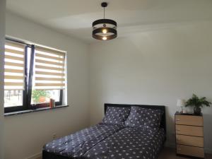 a bedroom with a bed and a window at New House White near Targi Kielce in Kielce
