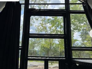 an open window with a view of trees at Tube - 06 Lockridge Park in Danville