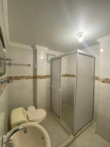 a bathroom with a shower and a toilet and a sink at Hotel Estefanía Princess 84 in Barranquilla +67 photos