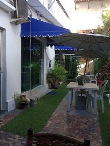 a patio with a table and an umbrella at Mar & Mar Suites in Arraial do Cabo