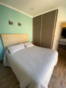 1 dormitorio con 1 cama grande con sábanas blancas en Loft Avis en San Luis