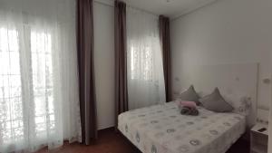 Ein Bett oder Betten in einem Zimmer der Unterkunft Dormir en Cádiz