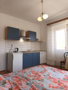a kitchen with a counter top and a kitchen with a table at Apartments and rooms by the sea Jelsa, Hvar - 4602 in Jelsa