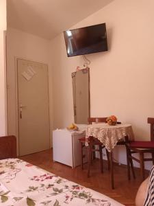 a room with a table and a mirror on the wall at Double Room Jelsa 4602a in Jelsa