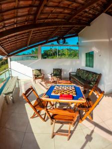 a room with a table and chairs and a chessboard at CASA TORRES in Bonito