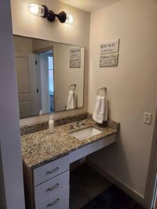 a bathroom with a sink and a mirror at The Best Spot in Downtown St. Louis!! in Saint Louis