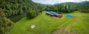 an aerial view of a truck on a field next to a river at Cinnamon House at Vanilla Club in Berner Creek