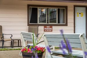 two benches and a no parking sign in front of a house at Lazy Duck Inn in West Yellowstone