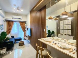 a kitchen and living room with a table and chairs at Happirest at Coast Residences, Pasay - 1 Bedroom with Balcony in Manila
