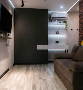 a living room with a couch and a television at CityView Apartment in Chişinău