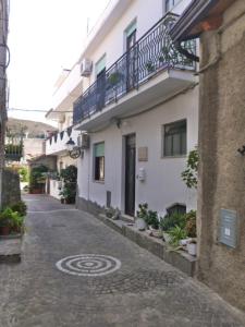 an alley with a building with a sign on it at Casa Bianca Grande in Rodi