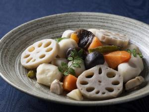 a bowl of food with vegetables on a table at Ark Hotel Royal Fukuoka Tenjin -ROUTE INN HOTELS- in Fukuoka