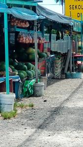 a produce stand with a bunch of watermelons on display at Rizki Homestay Nibong Tebal in Nibung Tebal