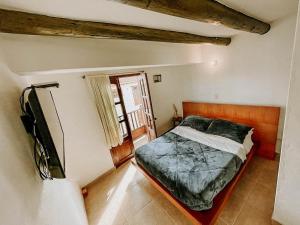 a bedroom with a bed and a tv in a room at Hotel Verona Villa de Leyva in Villa de Leyva