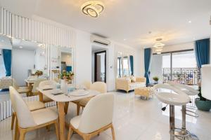 a living room with a table and chairs at Saigon Royal Apartment 3 bedrooms 4 beds for 30 nights stay above in Ho Chi Minh City