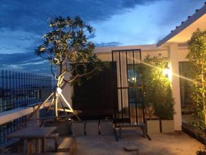 a balcony with a table and a tree on it at Me 2 Kamphangsaen in Kamphaeng Saen