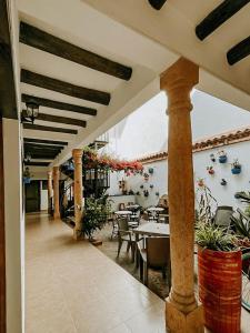 an outdoor patio with tables and chairs and a dining area at Hotel Verona Villa de Leyva in Villa de Leyva