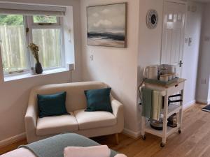 a living room with a couch and a table at The Garden Studio in Broadstairs