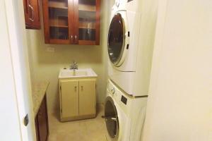 a kitchen with a washing machine and a sink at Spacious 4bd25ba Retreat Near Hospital & Tumon in Tamuning