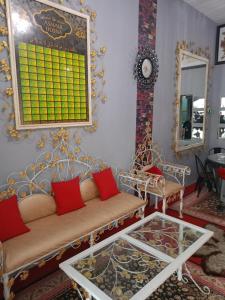a living room with a couch and a mirror at Homestay ALHAQIM in Pontian Kecil