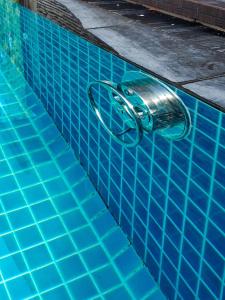 a swimming pool with a faucet in the water at Rabbit House แรบบิท เฮ้าส์ in Ban Han Tra Fang Nua