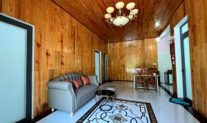 a living room with a couch and a table at Phu Nam House - Resort in Phú Quốc