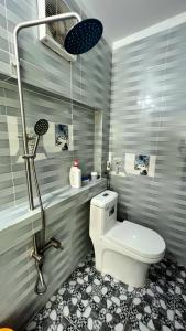 a bathroom with a toilet and a shower at Phu Nam House - Resort in Phú Quốc