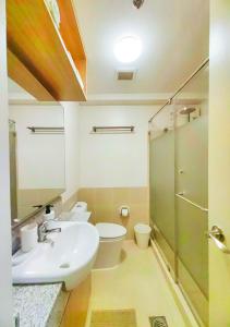 a bathroom with a sink and a toilet and a shower at Brand New 2BR unit 7min to Gateway Mall Cubao in Manila