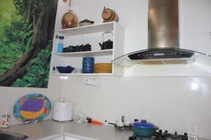 a kitchen with a counter top with a stove at Culture Paradise 3BR 2 story Townhouse Cabramatta in Cabramatta