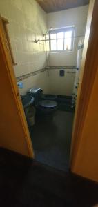 a bathroom with two toilets and a window at Punta Ballena- Rancho Civil- Casa de Campo, Piscina y Playa in Punta del Este