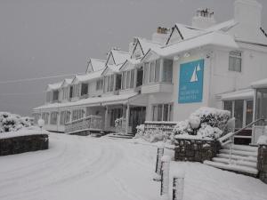 a snow covered street in front of a building at Trearddur Bay Hotel in Trearddur