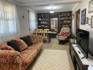 a living room with a couch and a dining room at Pomona Noosa Hinterland Homestay in Pomona
