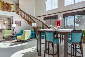 a living room with a table and chairs at Best Western Plus Victoria Inn & Suites in Victoria