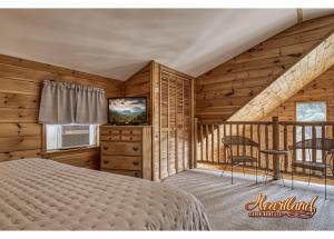 a bedroom with a bed and a television in a cabin at Honeymoon Cabin with Great Mountain View and Hot Tub in Gatlinburg