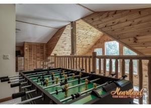 a large billiard table in a room with wooden walls at Honeymoon Cabin with Great Mountain View and Hot Tub in Gatlinburg