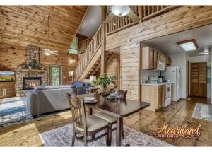 a kitchen and living room with a table and a couch at Honeymoon Cabin with Great Mountain View and Hot Tub in Gatlinburg