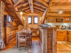 a kitchen and dining room with a table and chairs at Appartement de Charme à Courchevel 1850 - 4 pers, Centre, Proche des Pistes, Balcon et Hammam - FR-1-631-163 in Courchevel